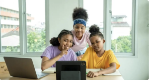 Three children on a computer.