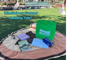 A "picnic" setting is depicted using the Riverside County Library System's summer reading prizes mixed with personal items. "What's in my Summer Reading Tote" is in text. 