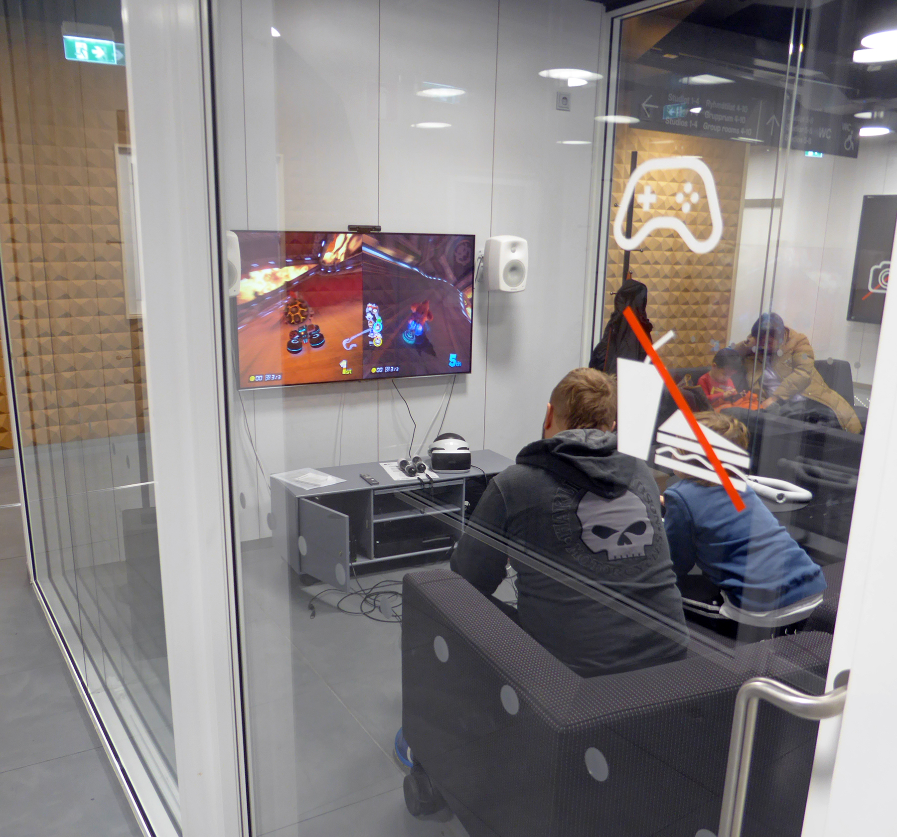 Oodi users play video games in 2019. (Photo Courtesy of Wikimedia Commons by Federico Leva)