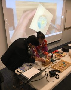 Image of a patron participating in wagashi making program.
