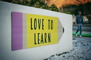 wall art with a drawing of a pencil with the phrase "love to learn" written on it