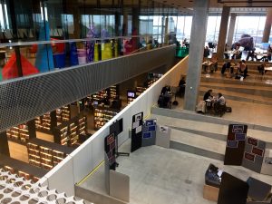 Image of people gathered and settled in at different spots in the DOKK1 Library.