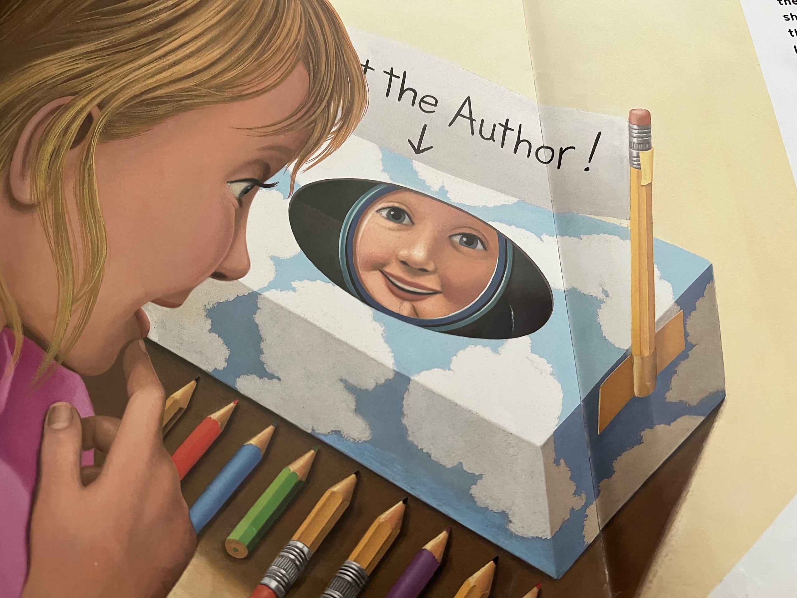 A child looks into a box that is labeled "Meet the Author" and sees her reflection.