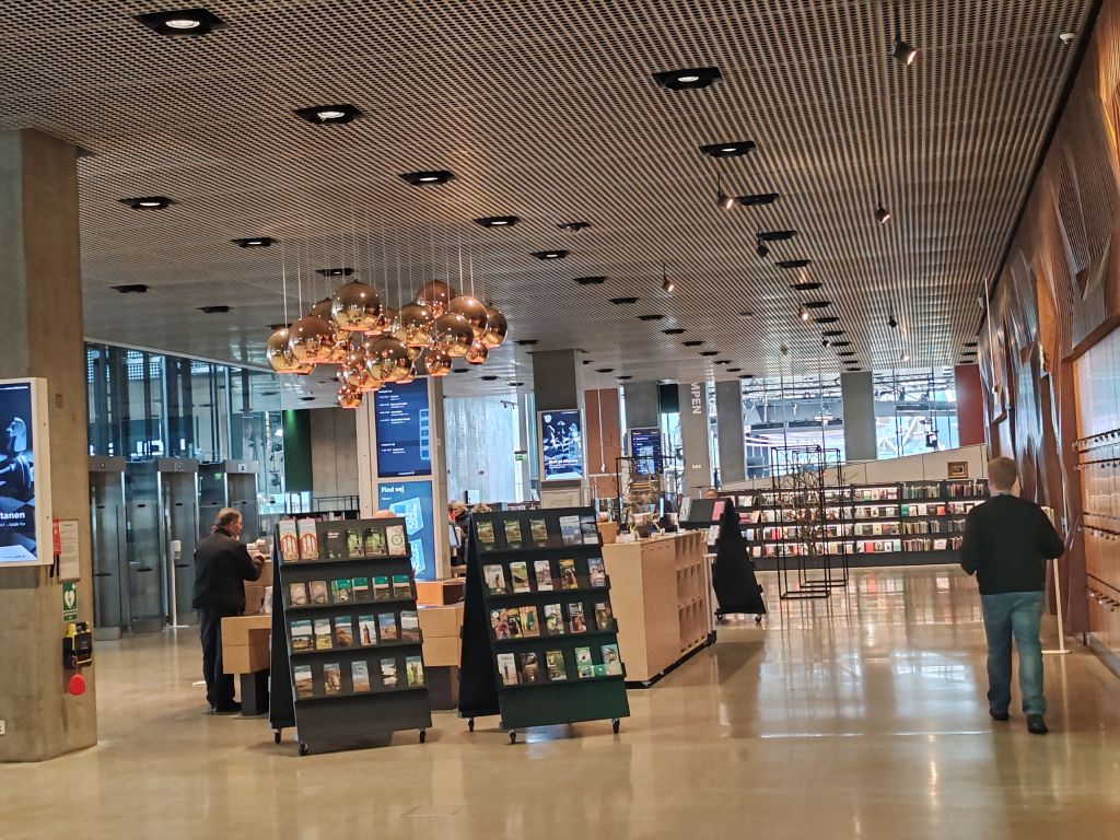Interior library space with book display stands inside DOKK1