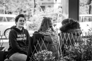 Black and white photo of three people in conversation.