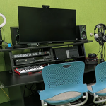 A computer station stocked with lighting and sound tools.