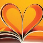 a heart formed from curled in pages on an orange background