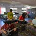 San Antonio Public Library - teens playing guitars in a teen library space.
