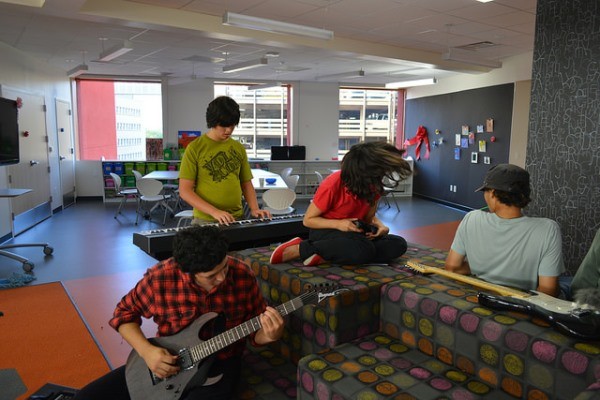 San Antonio Public Library - teens playing guitars in a teen library space.
