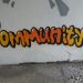 The word community on a white wall as graffiti