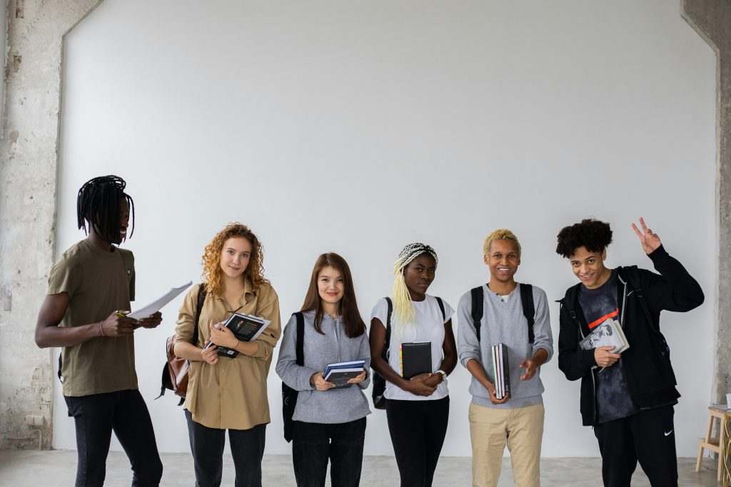 A group of multiethnic students standing in a row.