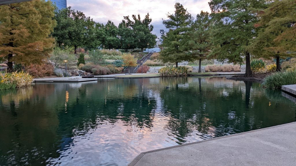 Image shows a reflections of the Oklahoma sunrise, reflecting over the pond.