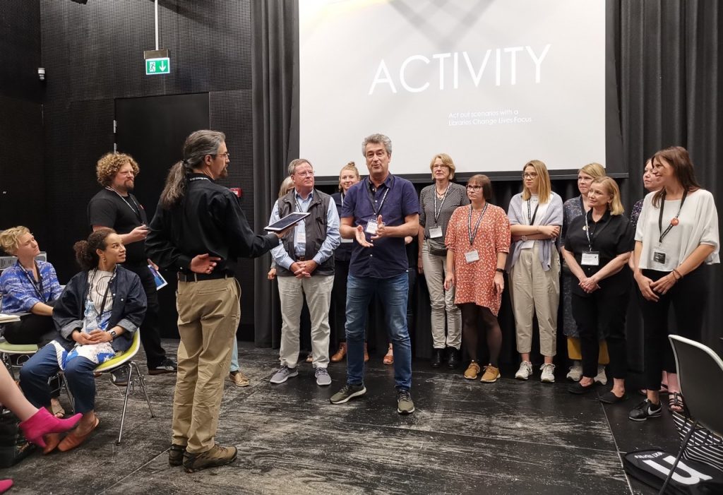 Michael in discussion with a group attending the presentation